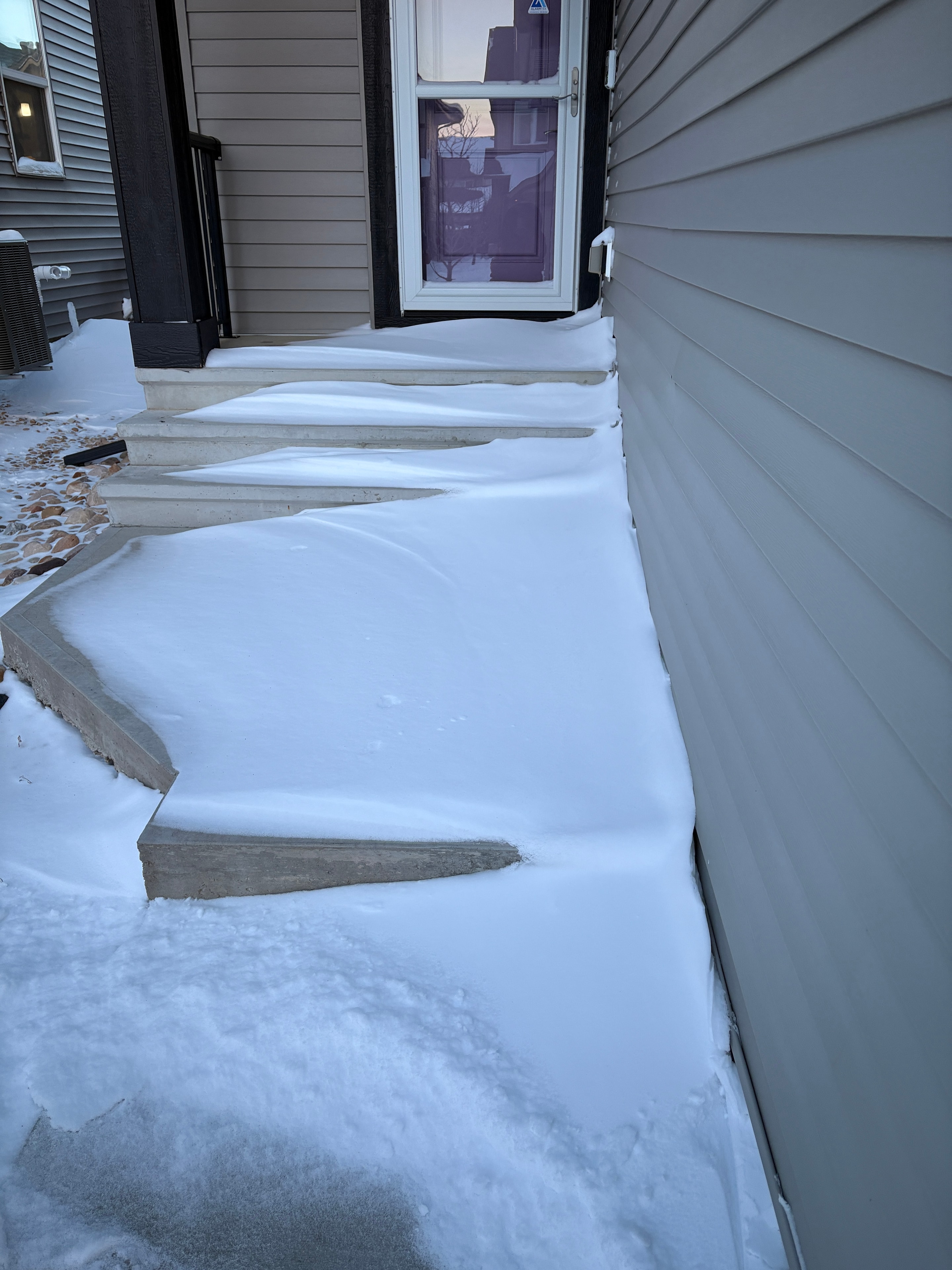 Heavy snow accumulation on building exterior and awning